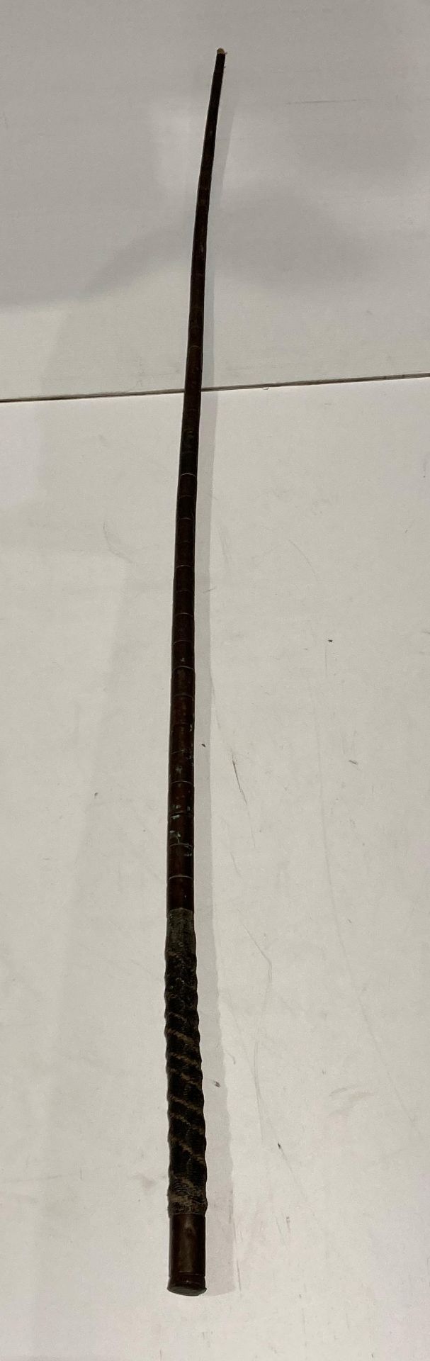 Old copper coated cattle whip missing rope end,