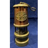 A brass and copper miniature model miner's lamp with Cymru Wales brass plate,