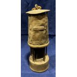 A brass miner's lamp marked M37,