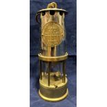 A brass and metal miner's lamp by The Protector Lamp and Lighting Co Ltd,