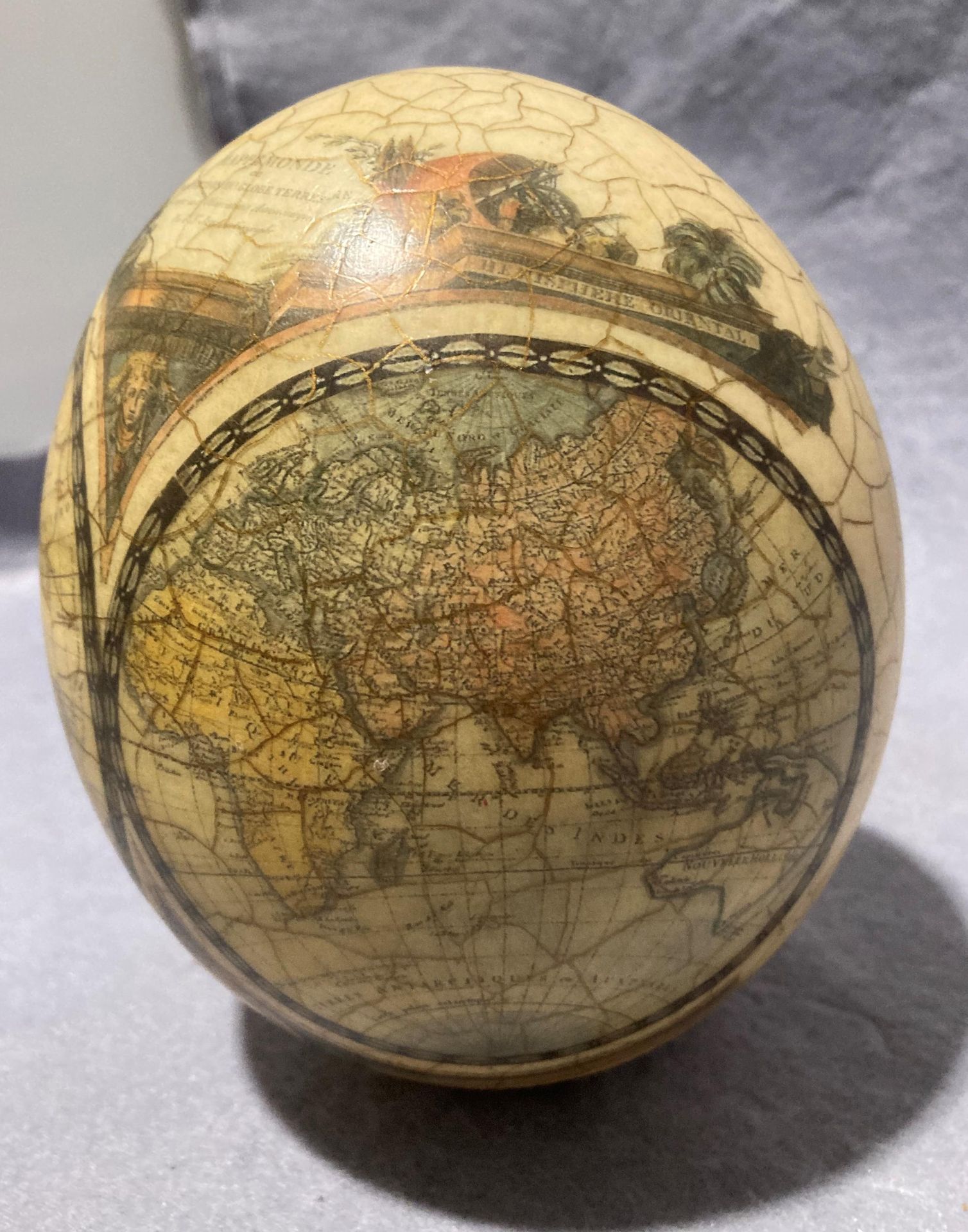A decorated ostrich egg with World Map and Africa animal scene (approximately 16cm high) with a - Image 3 of 11