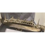 A modern metal model of a passenger liner on plinth,
