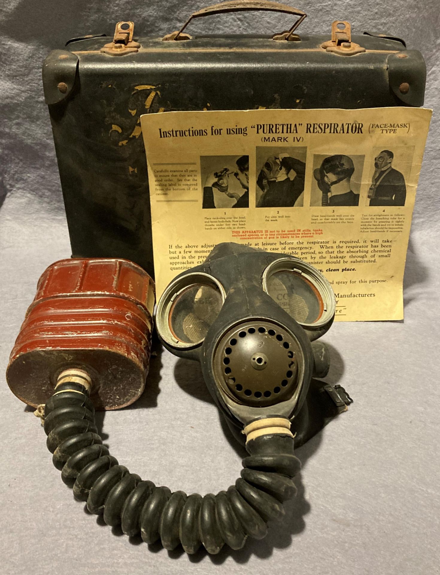 A vintage Puretha Mark IV respirator face mask (missing straps) in case with designed instructions,