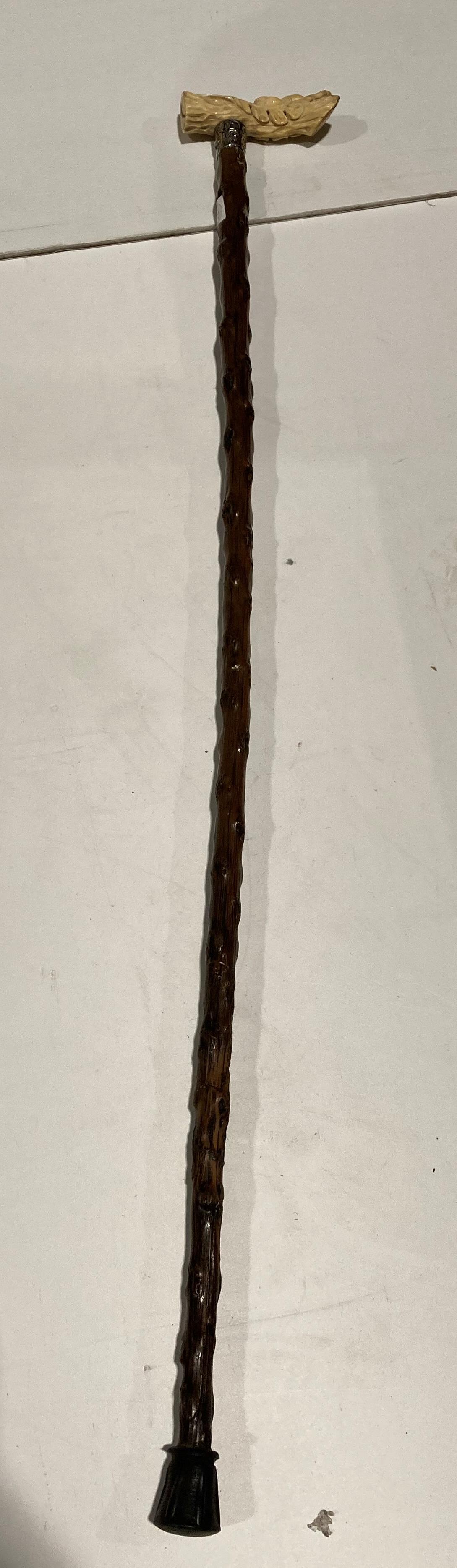 Brown wooden hand made walking stick with silver collar and a resin hand-carved acorn and leaf