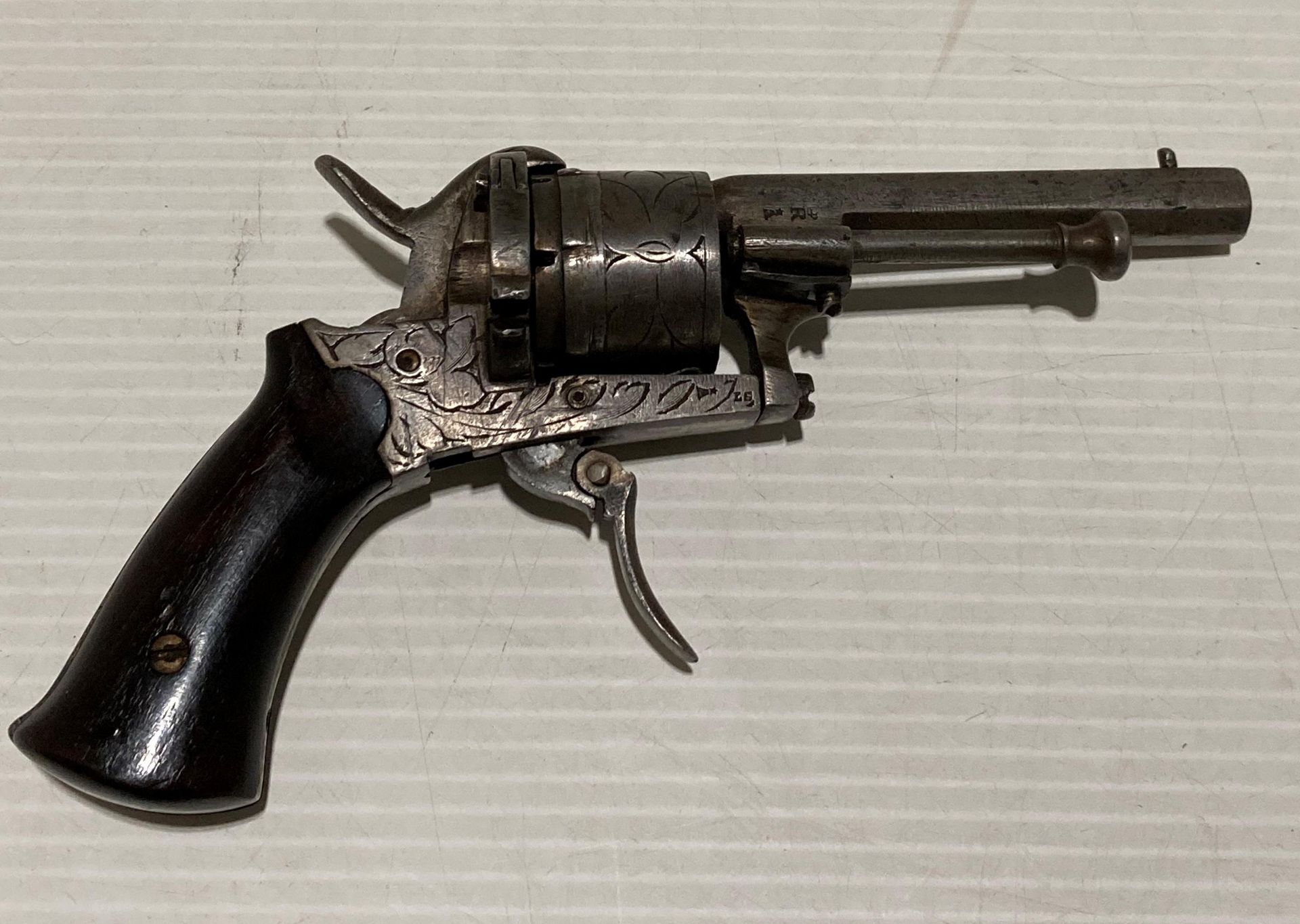An antique six shot 7mm calibre circa 19th Century revolver with foldable/retractable trigger