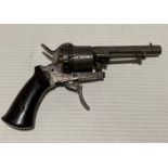 An antique six shot 7mm calibre circa 19th Century revolver with foldable/retractable trigger