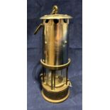 A metal and brass miner's lamp, missing badge,