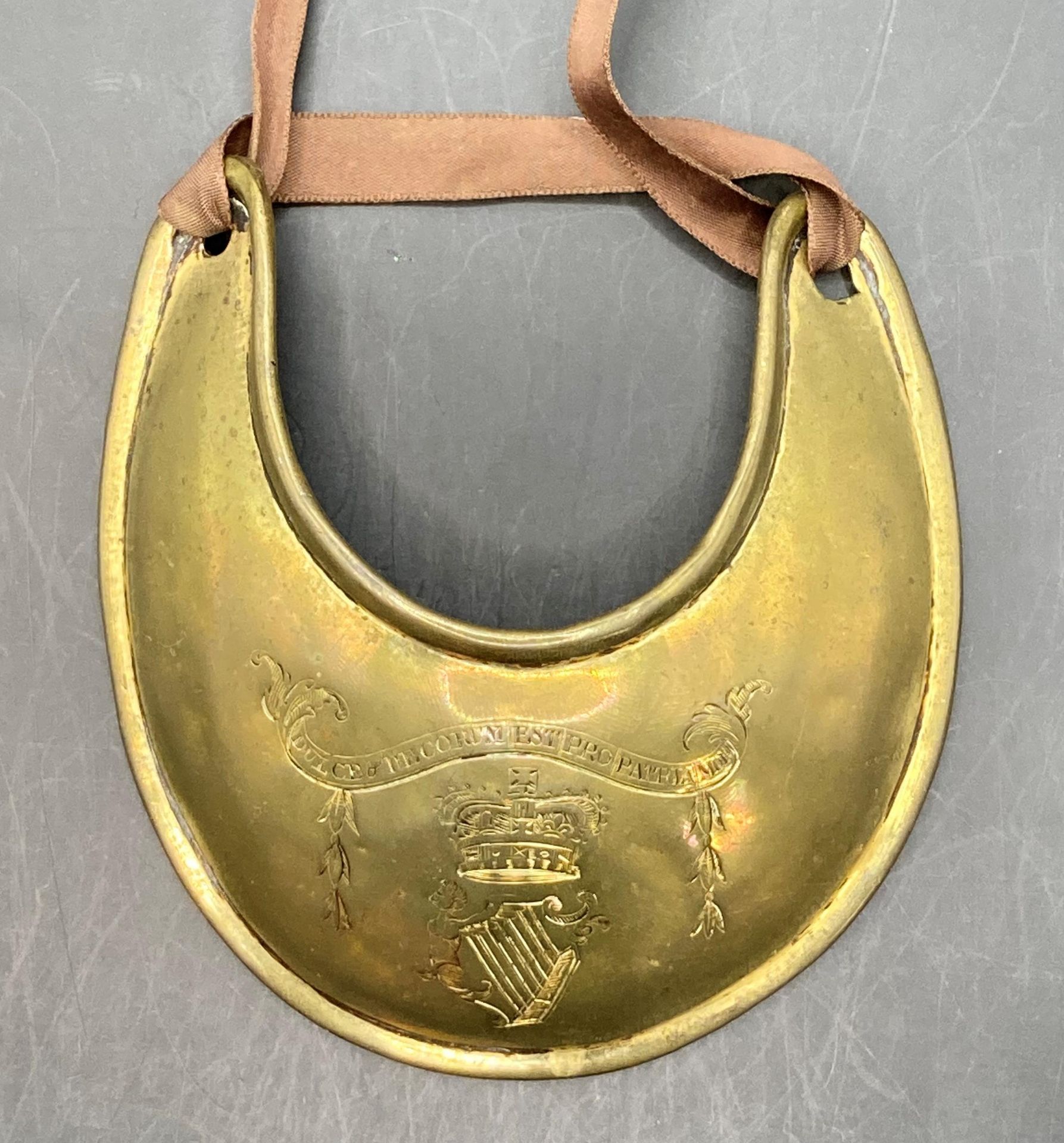 An Irish brass Gorget 'Dulce de Corum Est Patria Mori' (Saleroom location: S3 GC2)