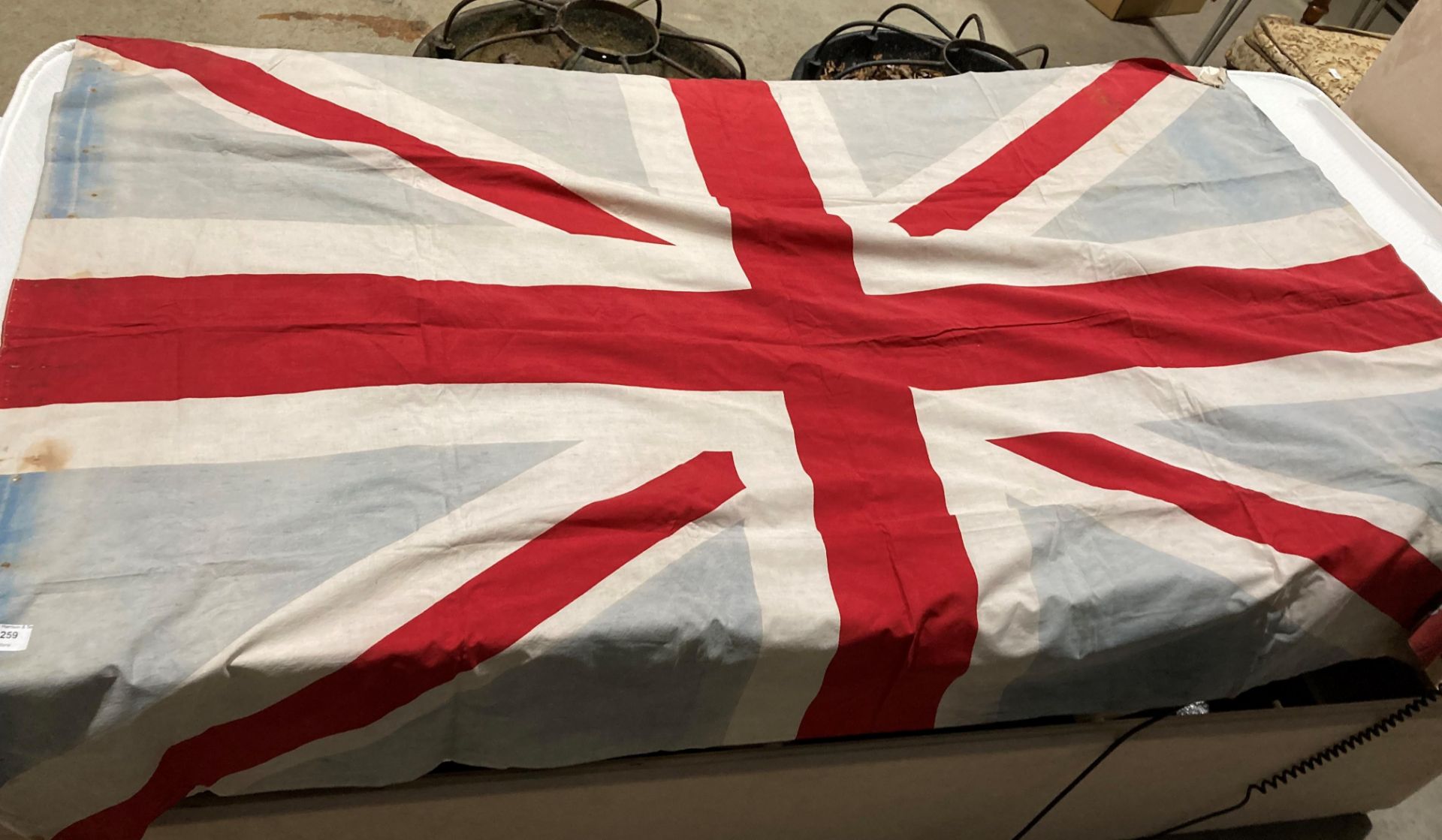 Union Jack flag, faded and pitted and with some small holes,
