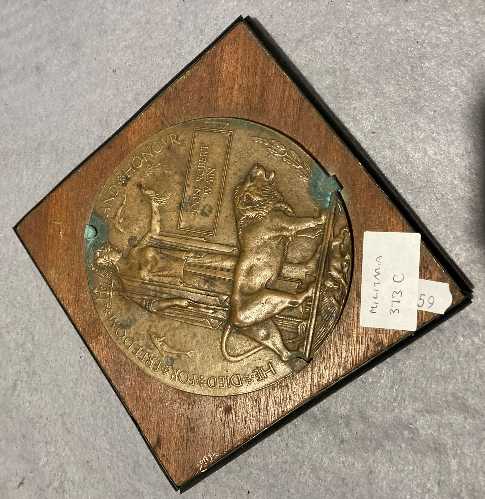 First World War memorial plaque to John Robert Wain mounted on a wood mount (Saleroom location: S2
