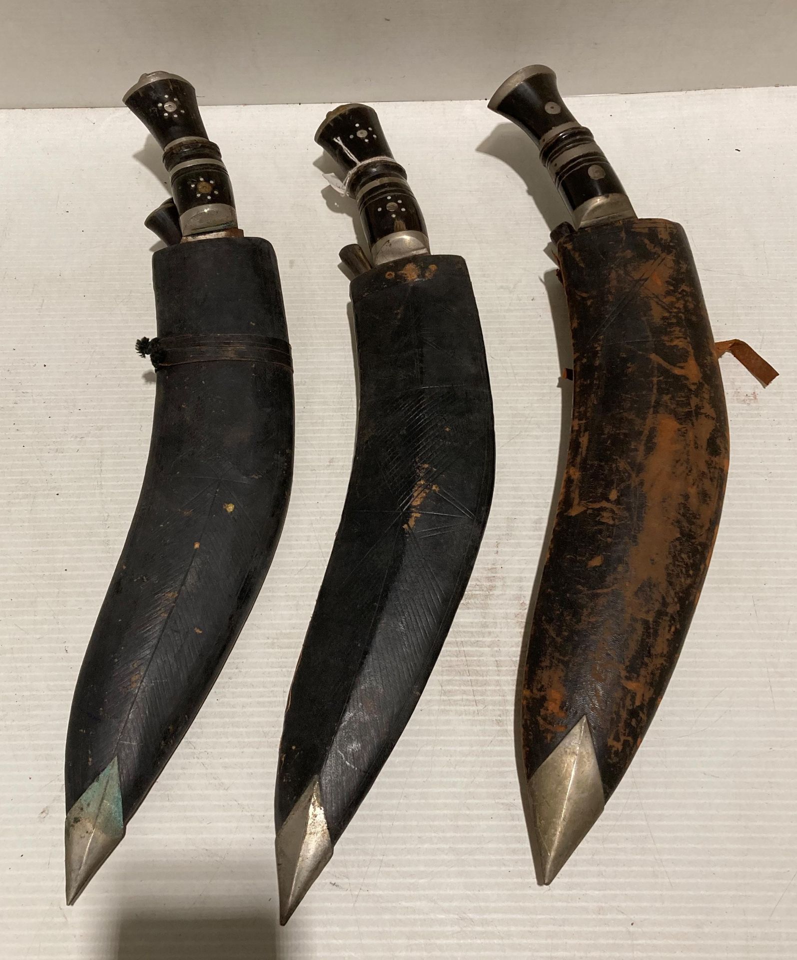 Pair of Gurkha Kukri knives with horn and metal handles,