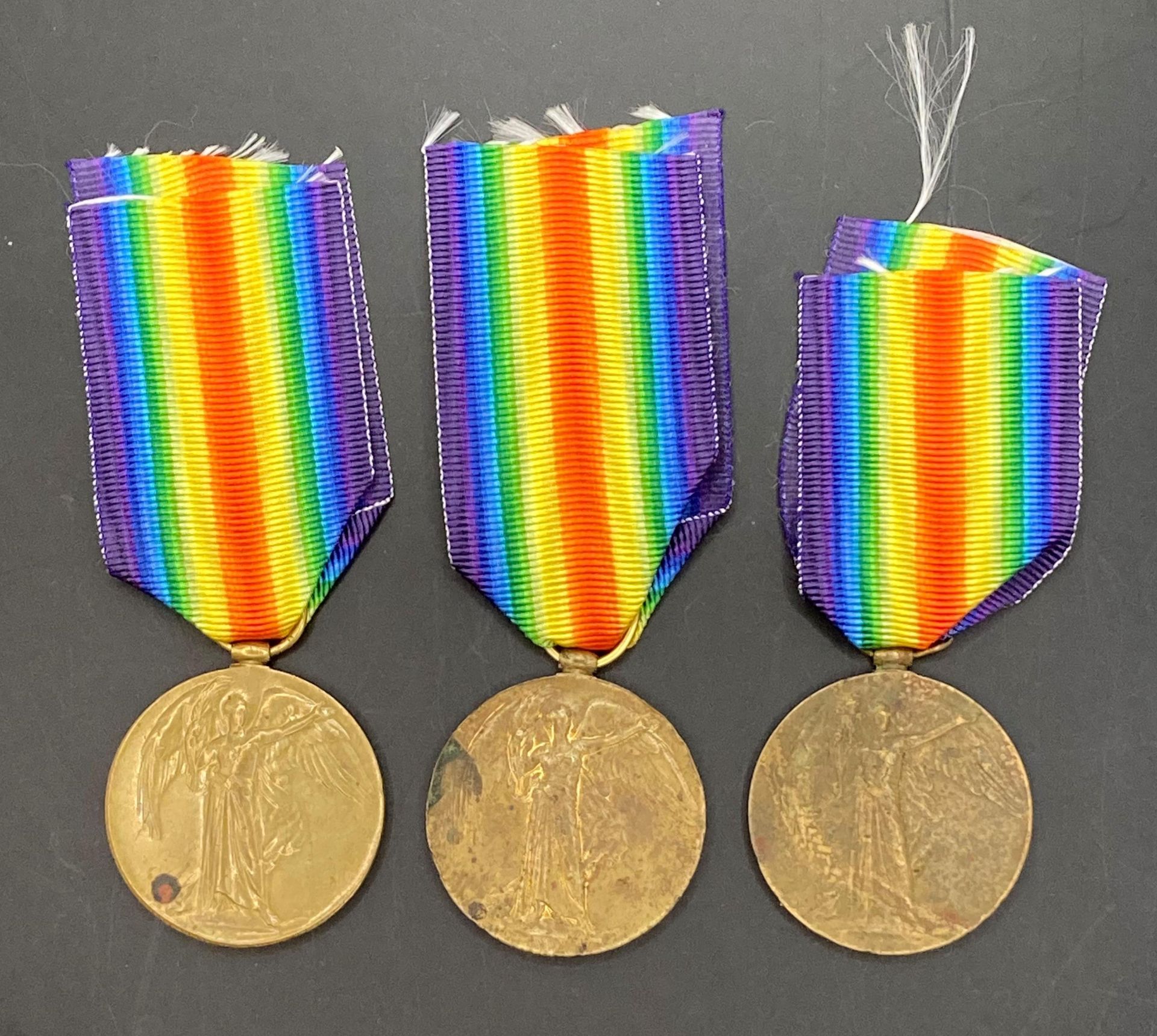 Three First World War Victory medals with ribbons to 1399 Gnr T Lloyd RA,