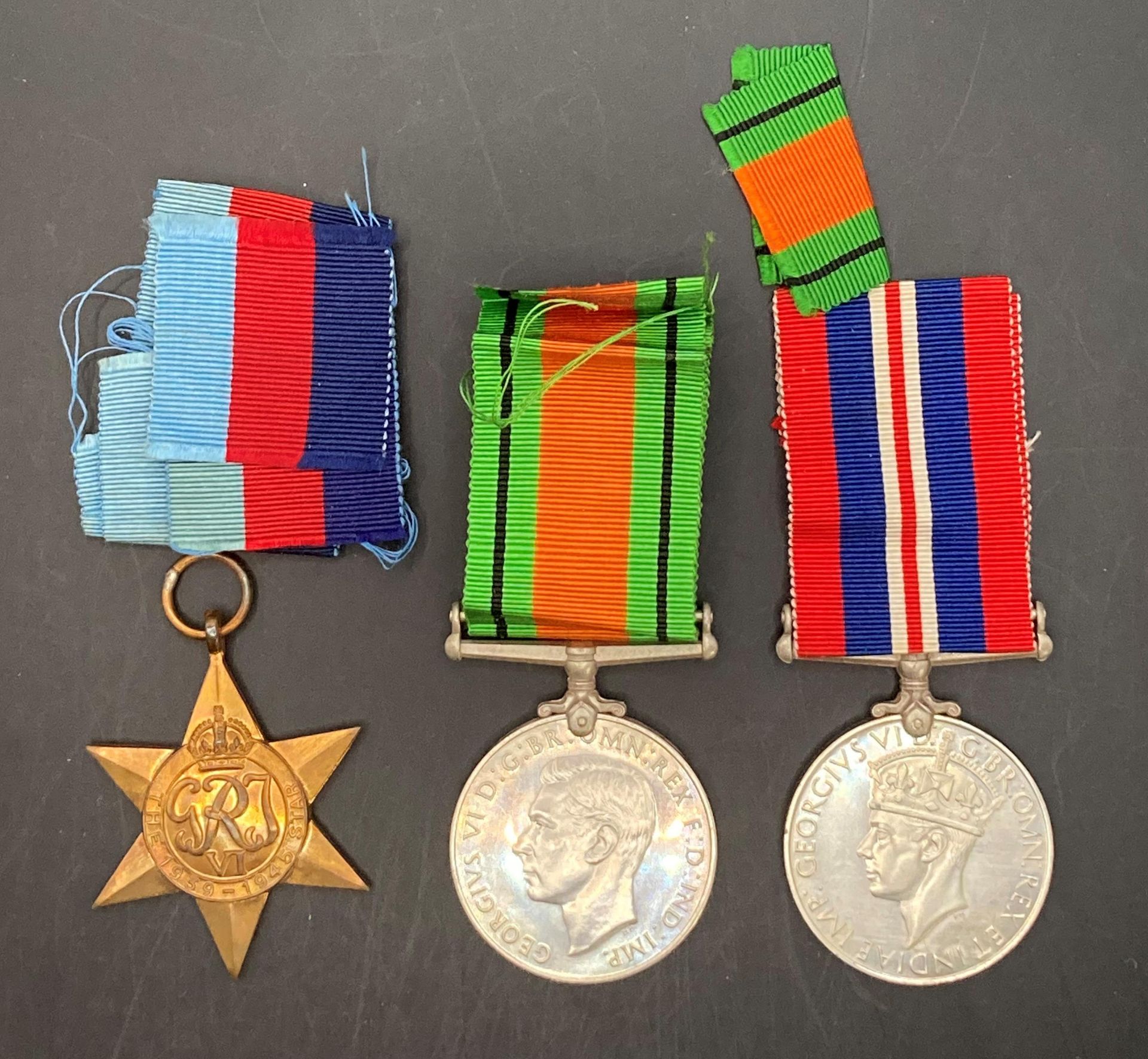 Three Second World War medals - 1939-1945 Defence Medal with ribbon,