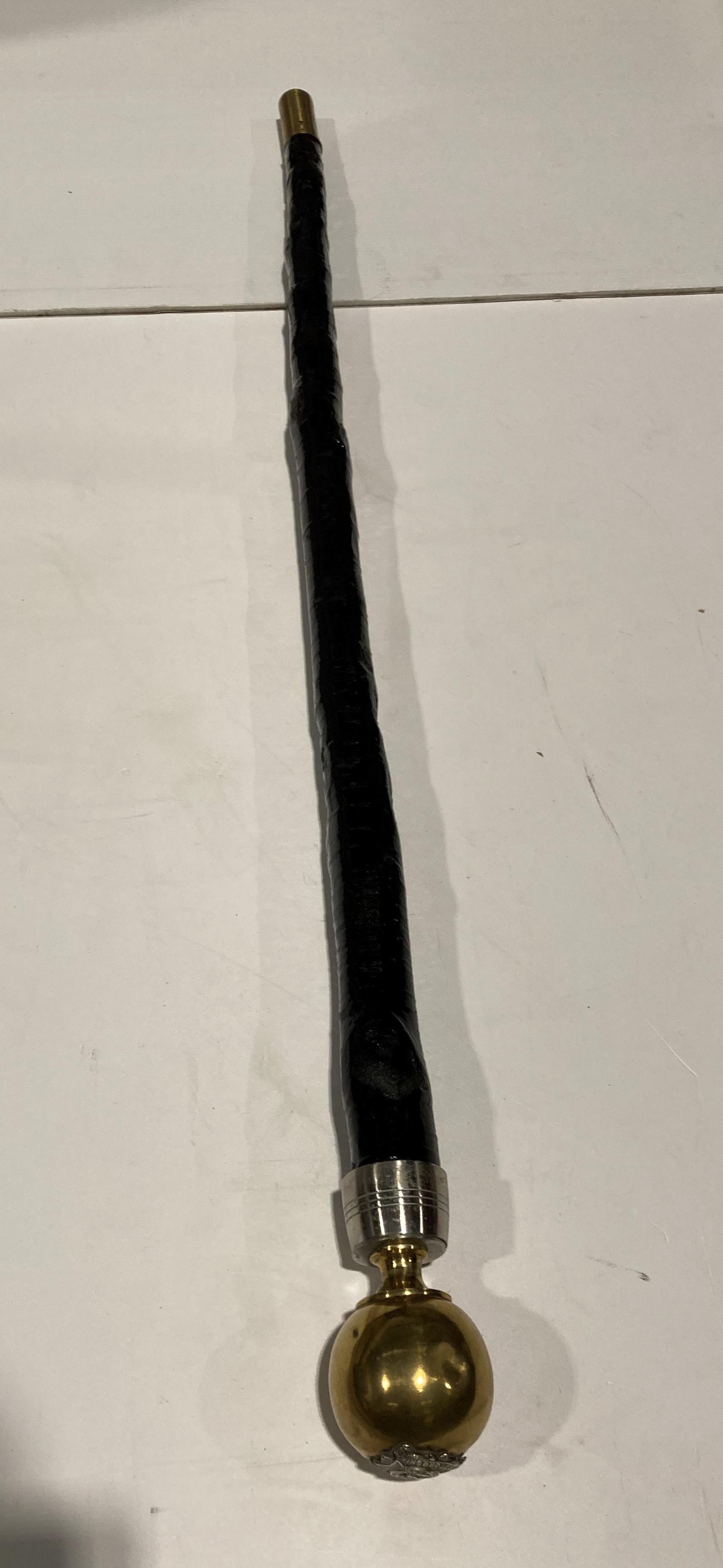 Black wooden walking stick with brass ball with a Bedfordshire 1.V.