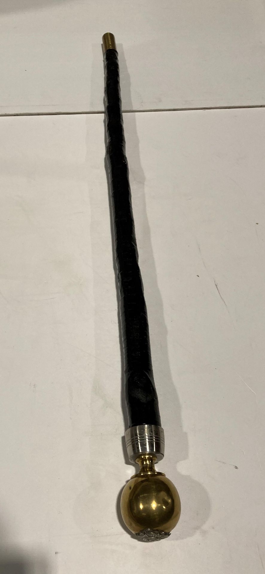 Black wooden walking stick with brass ball with a Bedfordshire 1.V.