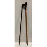 Two wooden walking sticks - one with leather bound handle (93cm long) and a right hand walking