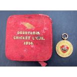 Sir Henry Fowler interest - a 9ct gold medal with red enamel badge Derby and District Cricket