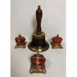 Four items including a vintage brass hand bell and three metal Elizabeth II crown money boxes