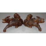 Pair of wooden hand-carved Oriental water buffalo with figures seated, approximately 10.