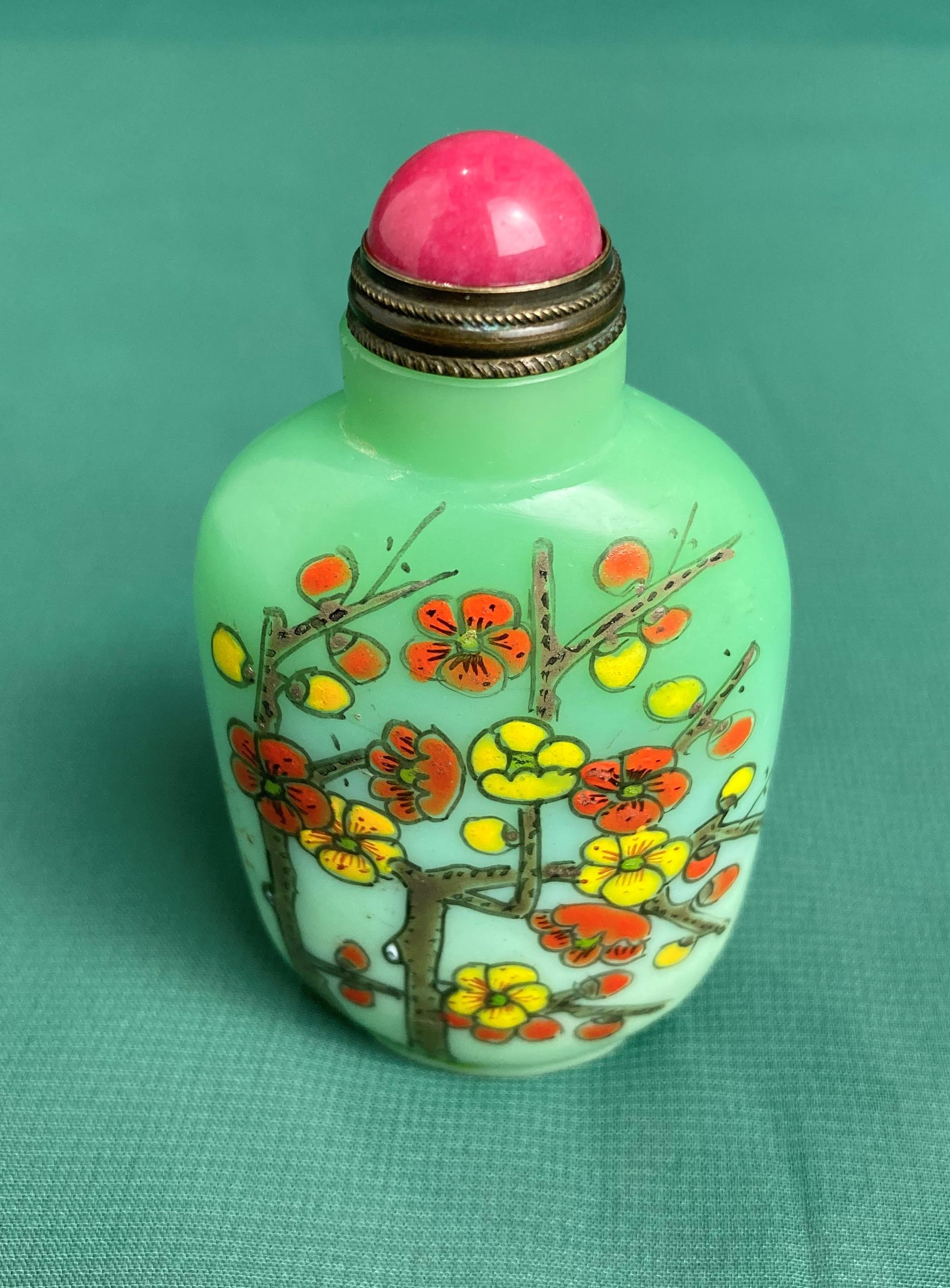 Oriental green glass hand-painted snuff bottle with spoon and stopper decorated with floral design