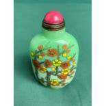 Oriental green glass hand-painted snuff bottle with spoon and stopper decorated with floral design