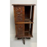 A Oriental wooden hand-carved revolving bookcase with dragons to panels and four dragon feet,