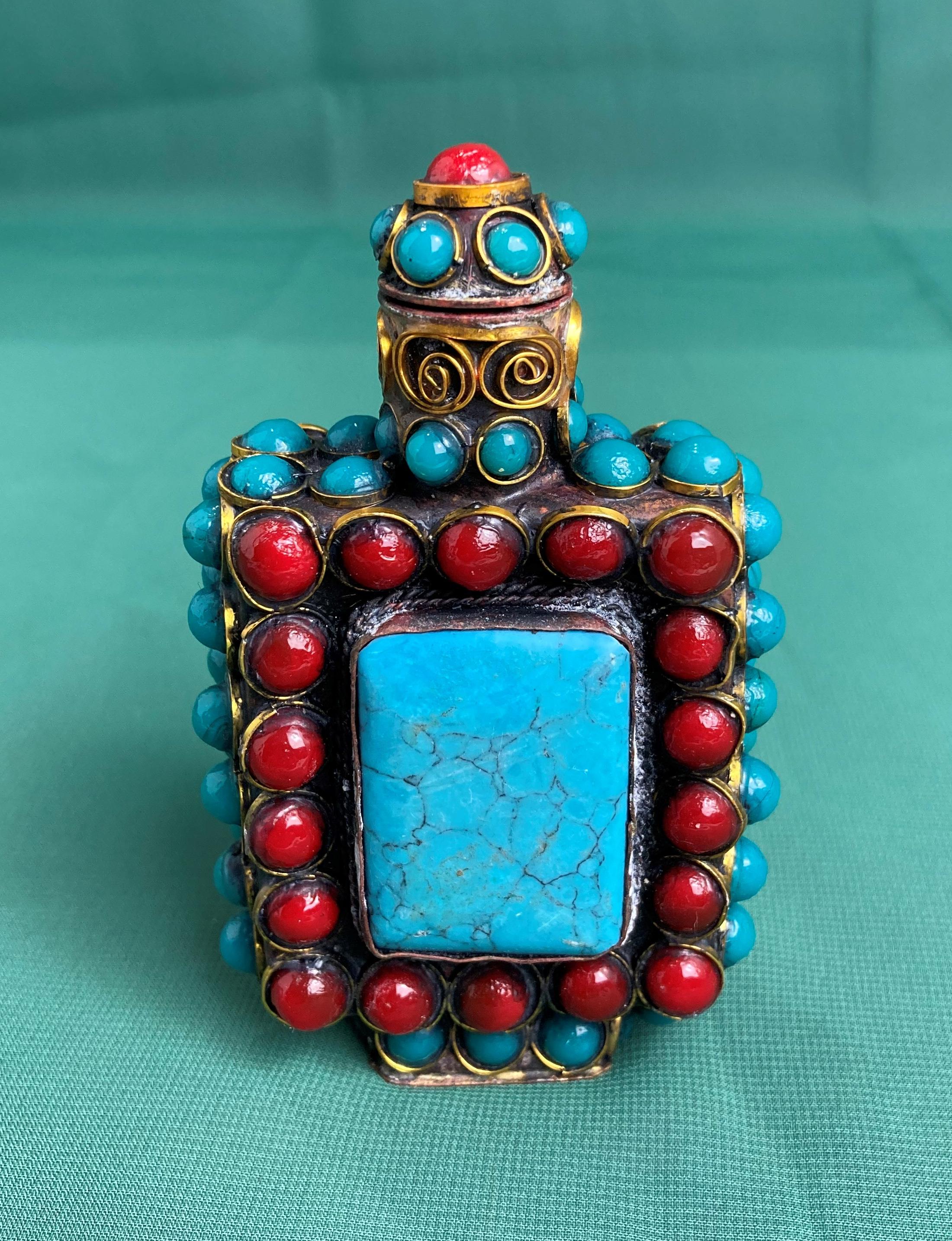 A Chinese/Tibetan hand-made metal work with deep red and turquoise coloured stones with stopper,