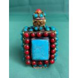A Chinese/Tibetan hand-made metal work with deep red and turquoise coloured stones with stopper,