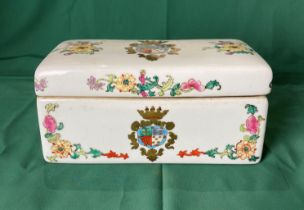 A vintage porcelain hand-painted box with Coat of Arms emblem and floral design,