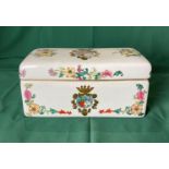 A vintage porcelain hand-painted box with Coat of Arms emblem and floral design,