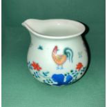 An Oriental hand-painted milk/cream jug possibly Jingdezhen with six symbol makers mark to base in