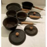 Five-piece cast iron pan set with wooden handles (saleroom location: S1QA06)