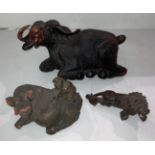 A large hand-carved wooden laid down water buffalo (damage to right horn) (39cm x 20cm high),