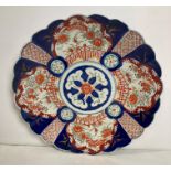 A large hand-painted Imari pattern scalloped plate,