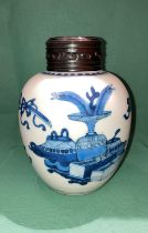 An antique Oriental blue and white ginger jar with engraved wooden lid,