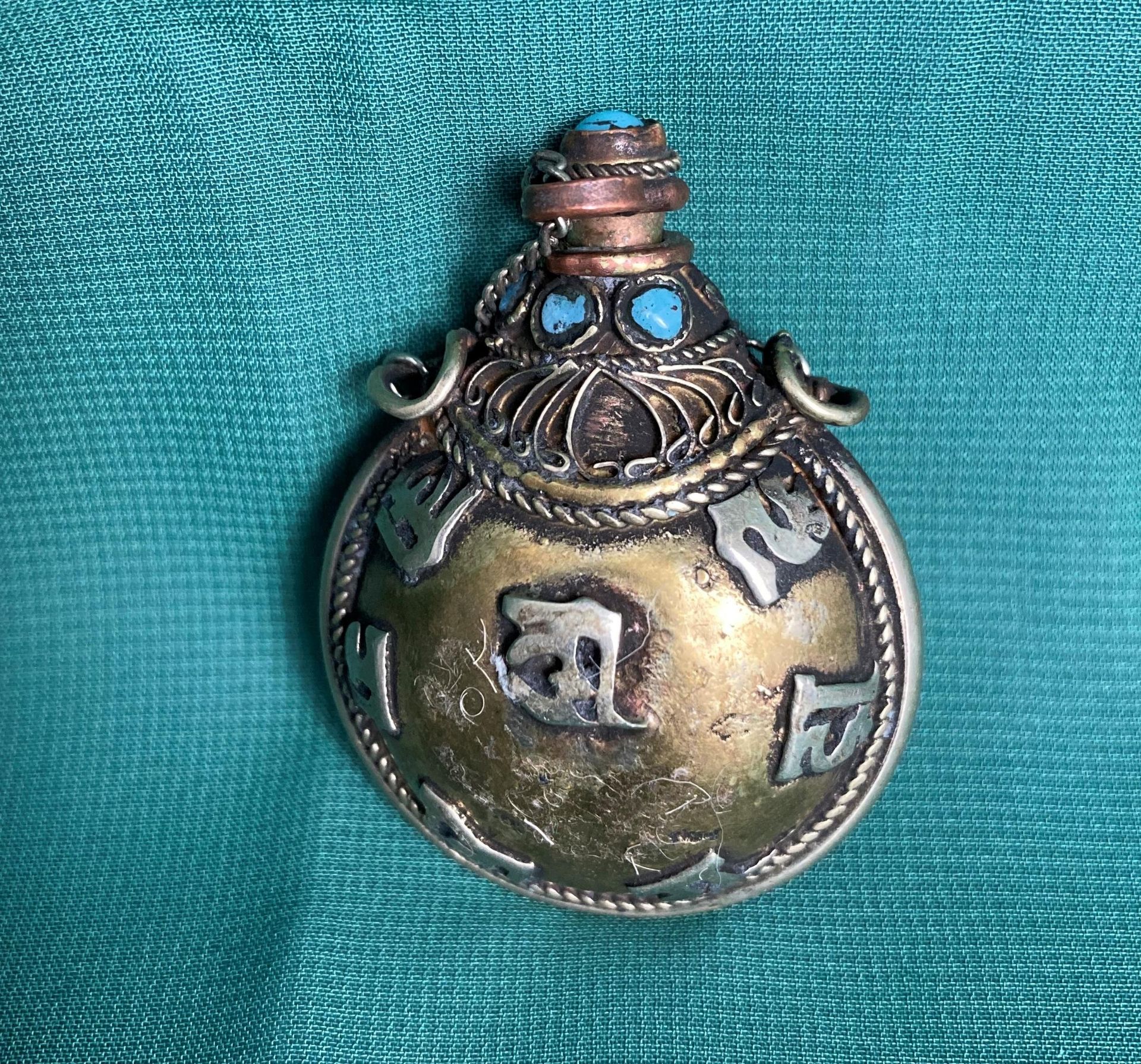 An antique Chinese/Tibetan hand-made metal snuff/opium bottle with light blue stones,