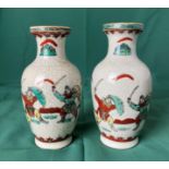 A pair of Oriental vases decorated with fighting warriors in a crackle glaze and stamp to base,