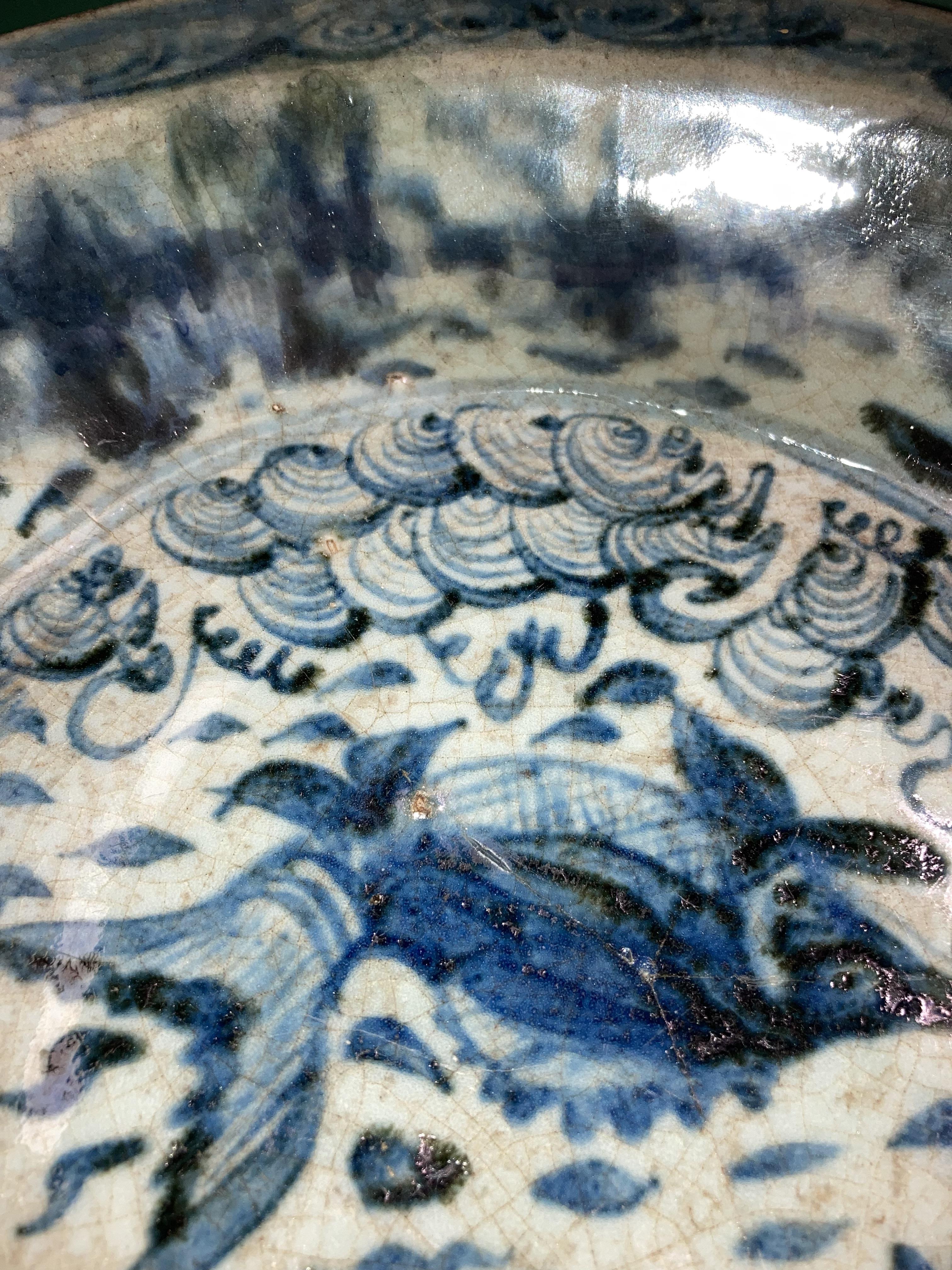 An antique Oriental blue and white glazed bowl with fish in pond to centre (bowl damaged and been - Image 6 of 6