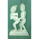 An early hand-carved natural light jade Oriental erotic figurine,