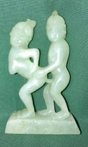 An early hand-carved natural light jade Oriental erotic figurine,