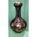 An early Kangxi black and gold dragon patterned vase with long neck and bud base with double circle