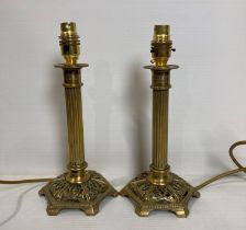 A pair of brass Corinthian column table lamps (one failed earth test,