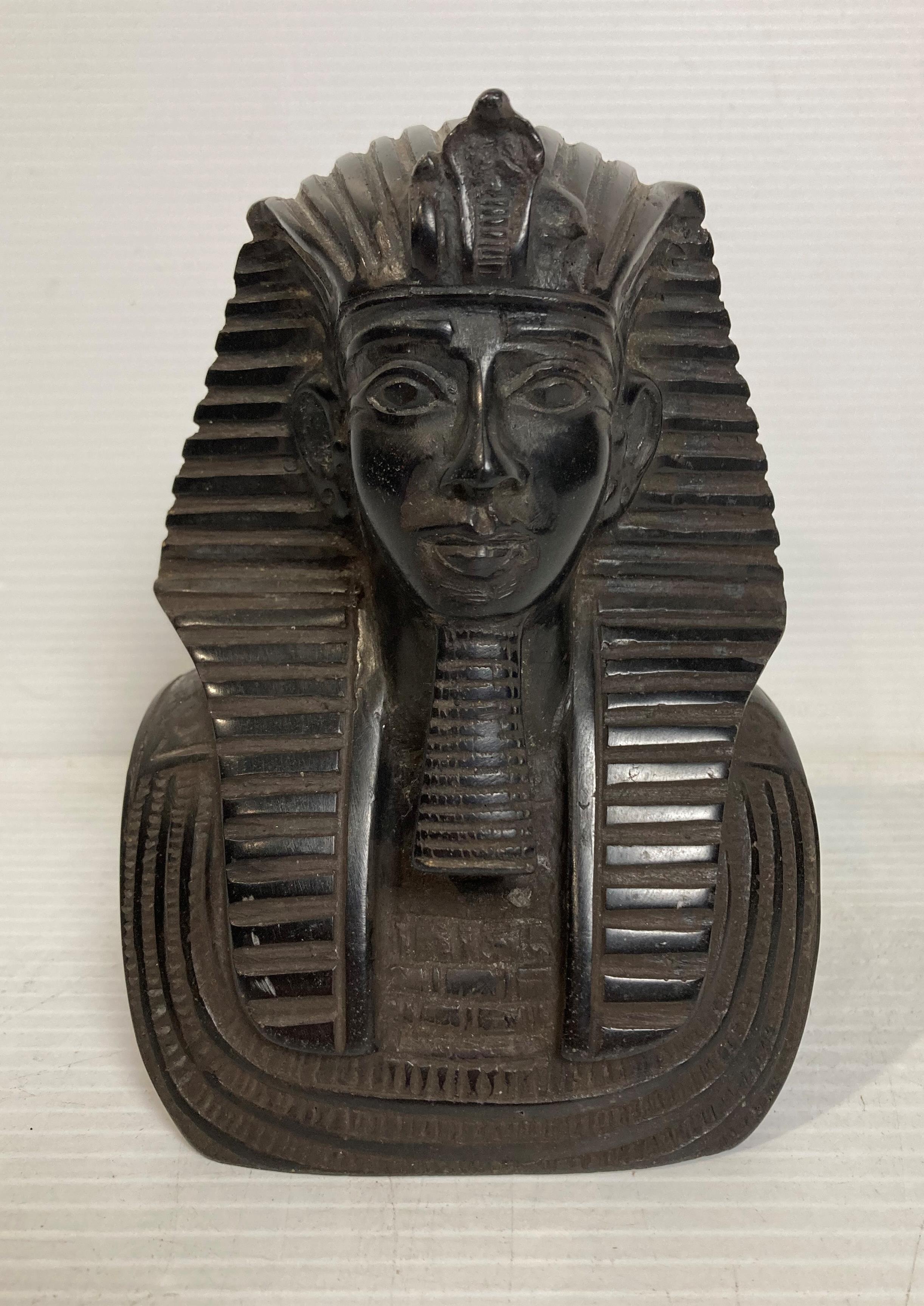 An Egyptian Pharaoh bust in polished blacks stone with hieroglyphics to each side,