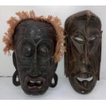Two vintage wooden hand-carved African face/wall masks,