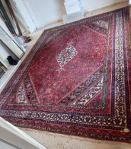 A red, green, blue and cream patterned oriental Hamadan rug,