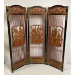 An Oriental wooden triple display screen with three hand-carved bird panels and etched detailed