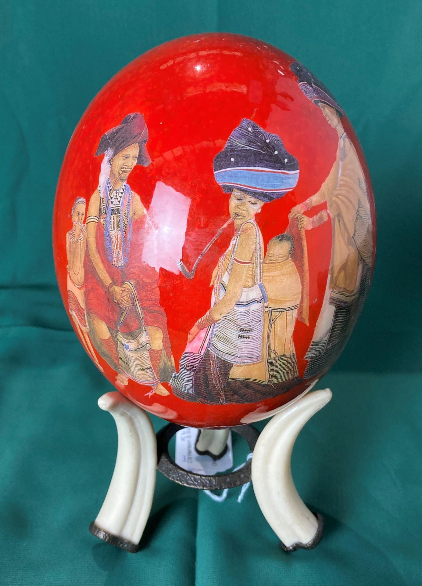 Hand-painted ostrich egg with African design on a reproduction tusk stand,
