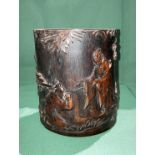 An Oriental stained and carved bamboo section with emperor and tree design,