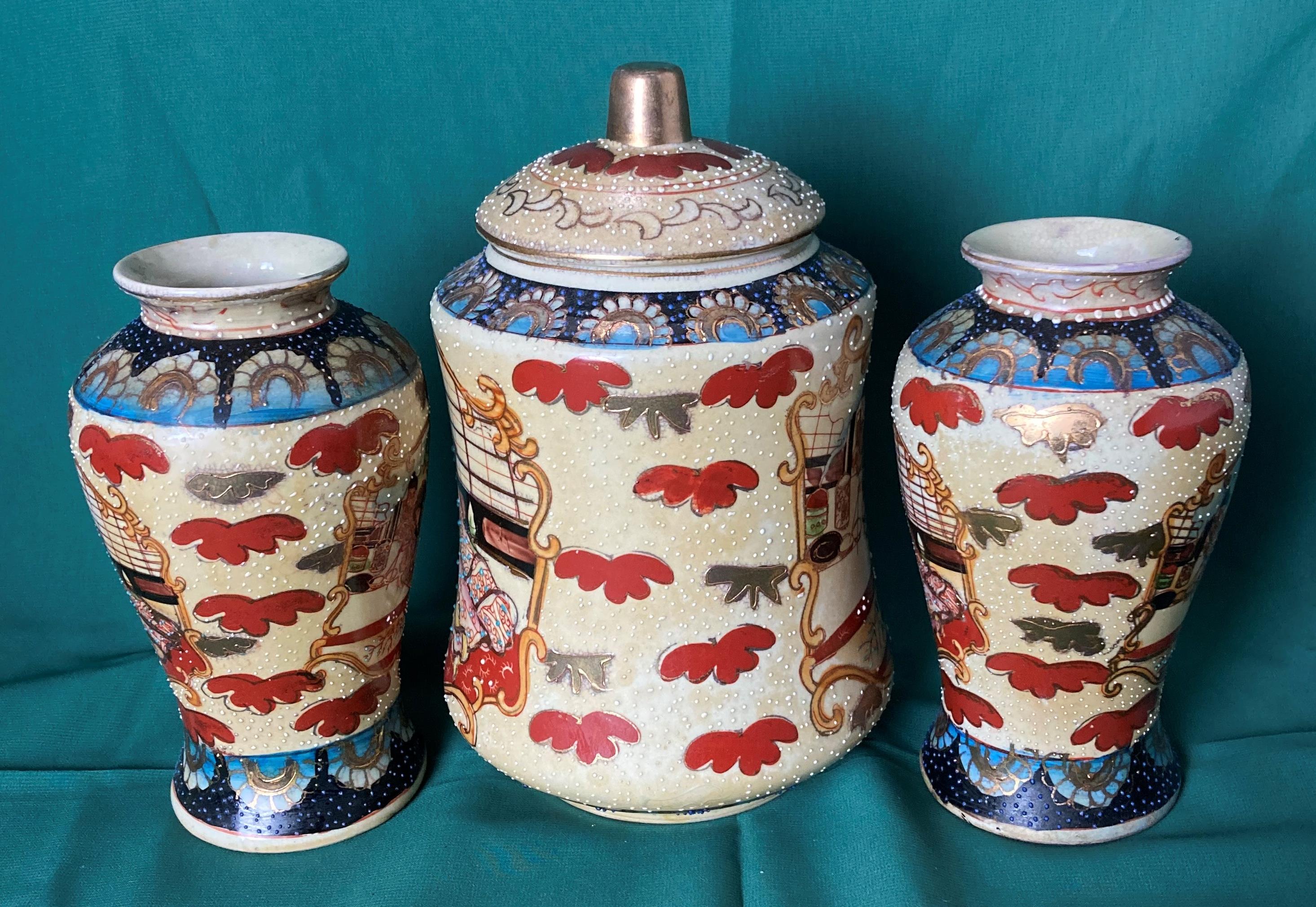 A Japanese Satsuma lidded jar with hand-painted Geishas and a matching pair of vases (saleroom - Image 2 of 2