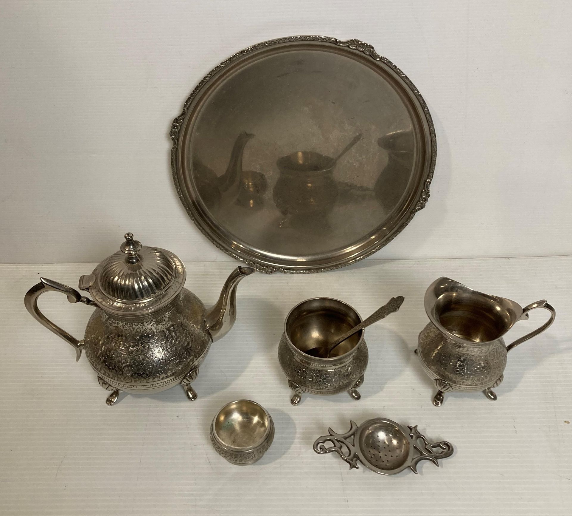 A six-piece Indian plated tea-service including tea pot, milk jug, sugar bowl, tray,